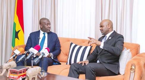 Kojo Oppong Nkrumah (left), Minister of Works and Housing,  interacting with  Thierno Habib Hann, Managing Director of Shelter Afrique