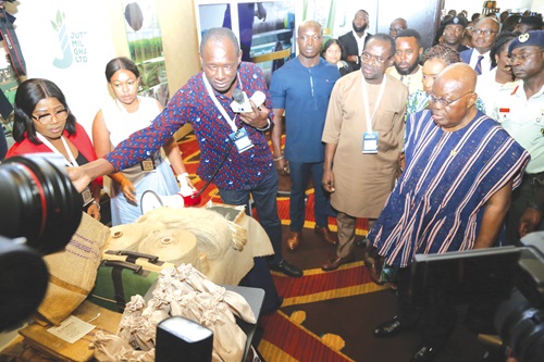 President Akufo-Addo being briefed by Adem Gariba (3rd from left), General Manager, Jute Mills Ghana Ltd., during an exhibition after the launch of the National SME Growth and Opportunity Summit in Accra. With him is Joseph Siaw Agyepong  (2nd from right), Group Chairman, Jospong Group of Companies. Picture: SAMUEL TEI ADANO