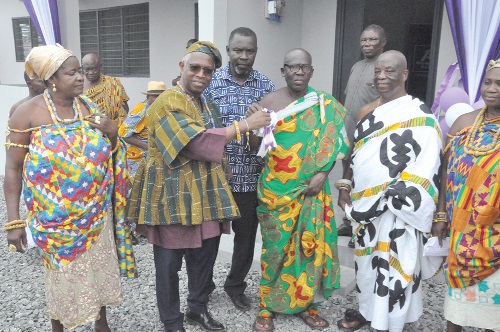  Amarquaye Armar (2nd from left), Board Chairman, First Atlantic Bank, presenting the keys to the staff quarters to Togbe Adza Kwadzo III, Dufia of Ziavi-Lume and acting President of the Ziavi Traditional Council, while other traditional leaders of Ziavi and Divine Bosson, MCE, Ho, look on