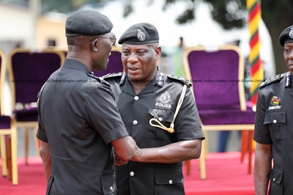 IGP Dampare (left) in a handshake with COP Yohuno