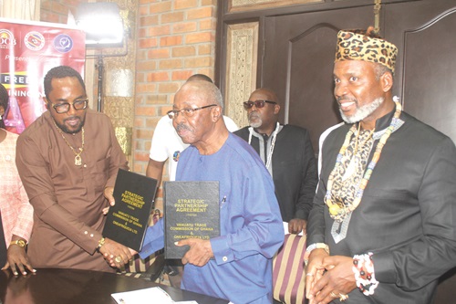 Prof. Hugh Keku Aryee (left), Vanuatu Trade Commissioner to Ghana, and Kwaw Paintsil Ansah (2nd from right), Founder and Chief Executive Officer, Film Africa Studios, exchanging the agreement after launching the ONEAFRIQUE24 in Accra. With them is King Rex Timothy McPherson Semako I &amp; VI (right), President of the Africa Diaspora Central Bank &amp; Chairman of ECO-6.  Picture: ESTHER ADJORKOR ADJEI 