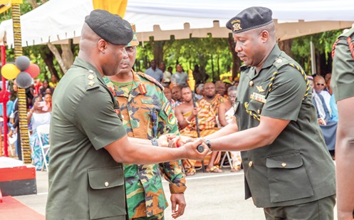  Lt Colonel Edward Sarpong Appiah (left), outgoing Commanding Officer of the 66 Artillery Regiment, presenting the Baton-of-Command to Lt Colonel Jalali Din Ibrahim