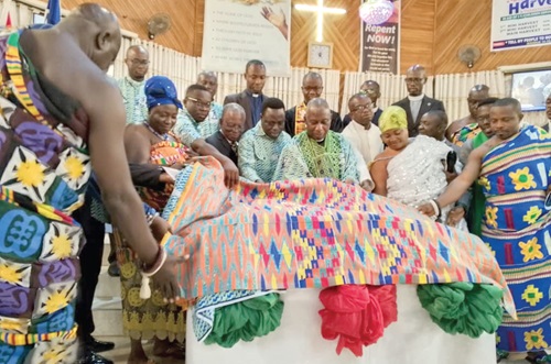 Very Rev. Professor John David Kwame Ekem (3rd from right), Translation Consultant, being supported by Very Rev. Dr John Kwesi Addo (4th from right), General Secretary of the Bible Society Ghana,  and some chiefs to unveil the Bono-Twi dialect New Testament Bible