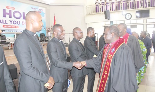 Rt Rev. Prosper Samuel Dzomeku (right), the Moderator of the Global Evangelical Church, congratulating one of the newly commissioned pastors