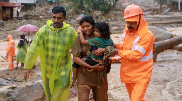Rescuers help residents move to safety
