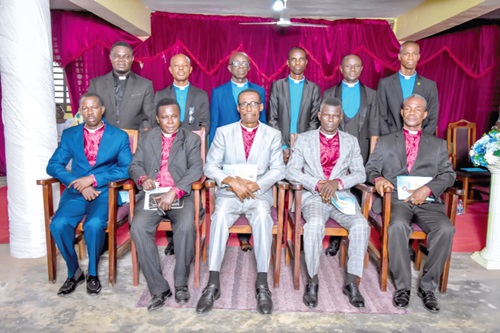 Rev. John Owusu (seated 2nd from right), International Mission Director, Dispensational Gospel Church, with the inductees and other leading members of the church