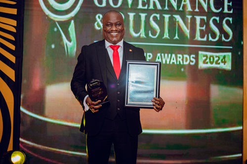 Augustine Appiah, Head of HR and Administration of BOST Company,  displaying the award