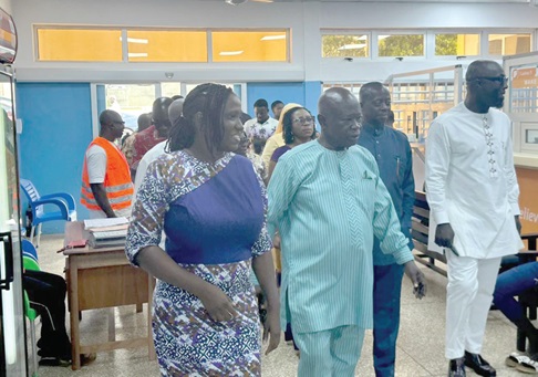 Nana Effah Apenteng (middle) with some board members at the Physiotherapy centre. INSET: The hostel facility under construction