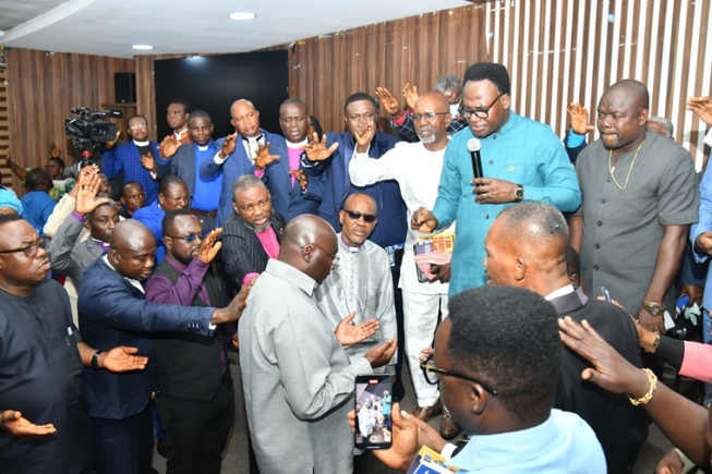 Members of the clergy praying for Dr Mahamudu Bawumia (arrowed), the NPP flag bearer, after their meeting in Accra 