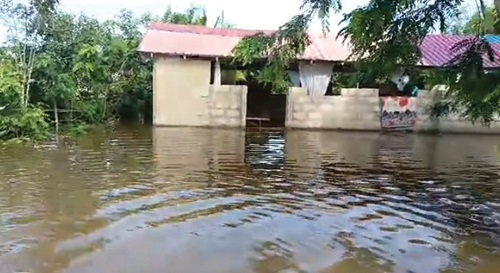 The Okyereko bridge. INSET: A house affected by the flooding