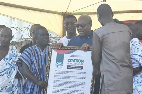 Leadership of the fishing communities presenting a citation to John Mahama 