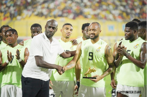  Black Stars coach Otto Addo congratulating Jordan Ayew after presenting him with a commemorative golden boot in the presence of his teammates