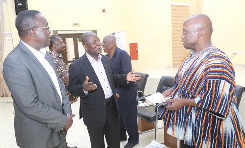   Daniel Domelevo (right), a former Auditor-General, interacting with  Prof. Wisdom Akpalu (left), Director, EfD Ghana, at the EfD seminar in Accra. With them is Prof. Daniel K. Twerefou (left), Department of Economics, University of Ghana, Legon. Picture: SAMUEL TEI ADANO