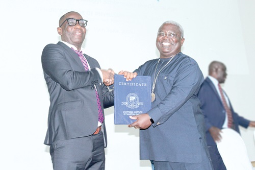  George Ohene Kwatia (right), President of the Chartered Institute of Taxation Ghana, presenting an award to Joseph Kyei Ankrah, Overall best student. Picture: ERNEST KODZI