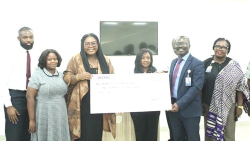 Josephine Eva Arthur (3rd from left), Zonal Head of Retail Bank, Access Bank, handing the cheque to Dr Kwame  Anim-Boamah (2nd from right), Chief Executive Officer of University of Ghana Medical Centre, as others look on