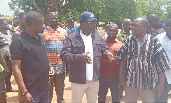 Martin Adjei-Mensah Korsah (middle), Minister of Local Government, Decentralisation and Rural Development, in a discussion with Issaka Anabida (right), DCE for Tempane, during the inspection of a bridge in the district. Looking on is Samuel Agyarko Larbi (left) SOCO Zonal Coordinator.