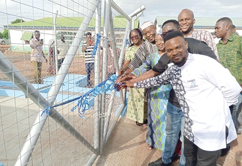 From left to right: Alfred Nunoo, Regional Manager of GGBL; Sampson Ahele Tettey of WaterAid Ghana; Nicolas Soyiri, MCE of Jirapa, and Naa Boburononi Amadu Hassan (in smock), the Ullo Chief, jointly inaugurating the water facility 