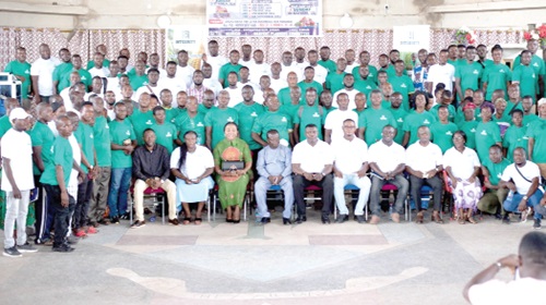 Gideon Quaye (seated 4th from left), Chief Executive, Integrity Commodities Limited, and some dignitaries with a section of the smallholder farmers after the event at Ejura in the Ashanti Region