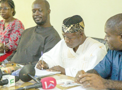 Dr Mumuni Seidu (2nd from right), Managing Director of Muus International Ltd, signing the MoU while Nana Akomea (right), Managing Director of the State Transport Corporation, looks on. Picture: CALEB VANDERPUYE