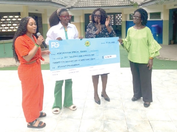 Paige Greenwood (left) with Sylvia Francois (2nd from right) after the presentation. With them are other officials of the school.
