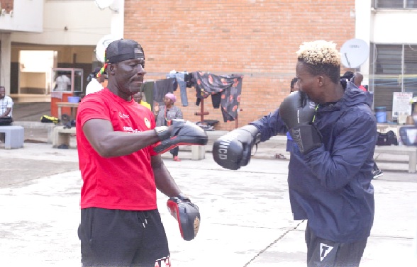 Samuel Takyi (right) hits the pad with trainer Lartekwei Lartey