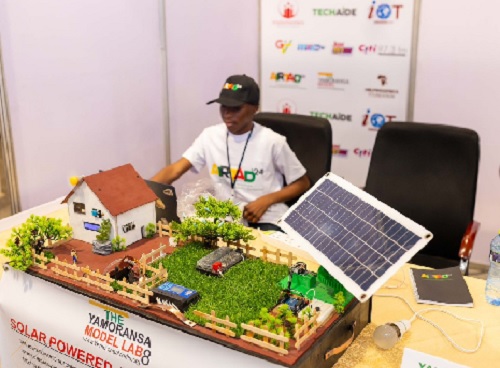 A participant showcasing a model of a solar-powered innovation