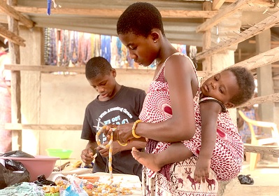 Young people are involved in the sale of beads at Agomanya market