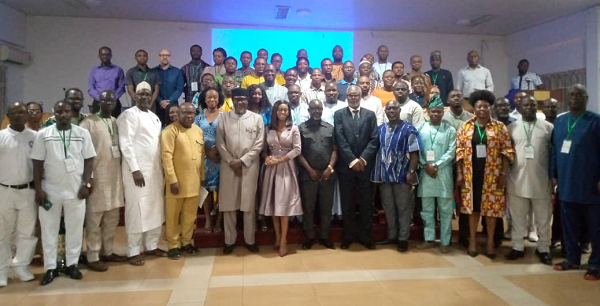 Dr Samuel Antwi-Gyekyi (5th from right), Director, Research Statistics and Information Management, Ministry of Communication and Digitalisation; George Amoo, Board Chairman, GMeT, and Eric Asuman, the acting Director-General, GMeT, with some participants and dignitaries after the closing of the forum