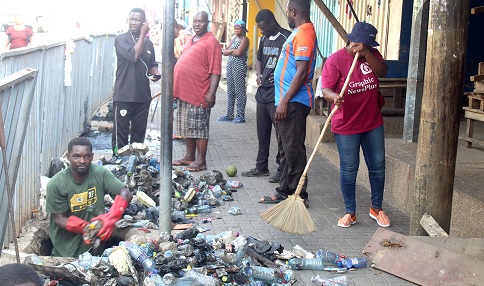 Some members of the Graphic and Zoomlion and some volunteers engaged in the clean-up exercise in the New Juaben Municipal Assembly.  Picture: ESTHER ADJORKOR ADJEI