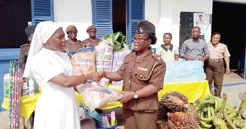 Reverend Sister Jusinta Kwakyewaa Osei (right) handing over the items to Lydia Odoi Yemoh, Chief Superintendent of Prisons 
