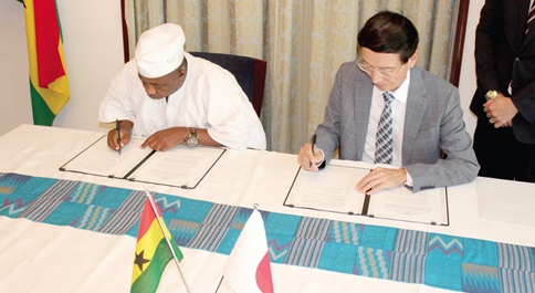 Mochizuki Hisanobu (right), Japanese Ambassador to Ghana, and Imoro Sanda, District Chief Executive, Daffiama-Bussie-Issa District Assembly, signing the grant. Picture: ERNEST KODZI