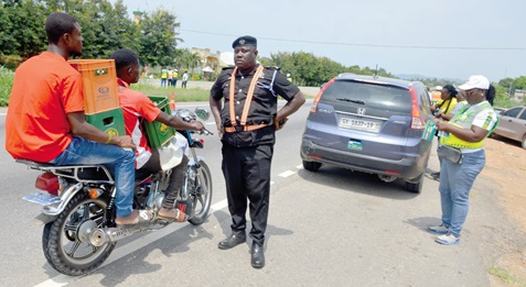 An official of the Motor Traffic and Transport Department of the Ghana Police Service enforcing road traffic regulations 