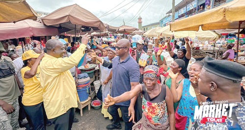 Alan Kyerematen (left), leader of the Movement for Change, responding to greetings at the Kasoa market