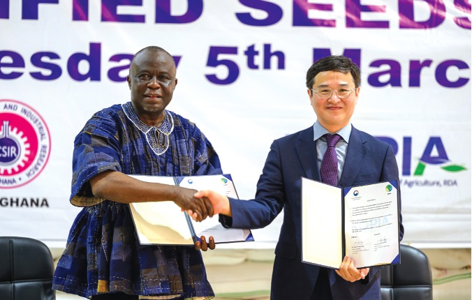 Yaw Frimpong Addo (left), Deputy Minister, Food and Agriculture in charge of Crops, in a handshake with Dr Kim Hwang-Yong, Director-General, RDA, after receiving the 300 metric tonnes of certified rice seedlings
