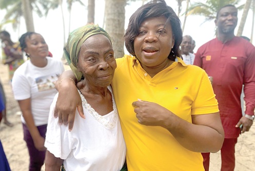 Ophelia Mensah-Hayford (right), MP for Mfantseman in the Central Region, embracing one of the women