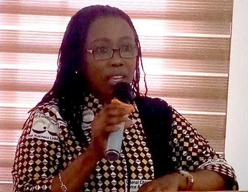 A section of the participants. Inset: Dr Emelia Assiakwa, National Treasurer of GNCCI, speaking at the event