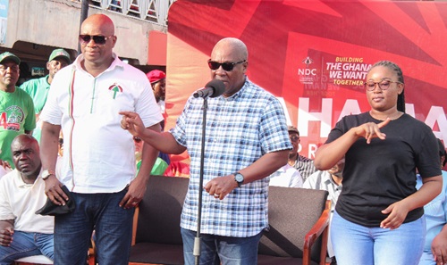 John Dramani Mahama, flag bearer of the NDC, addressing spare parts dealers at Abossey Okai. With him are Abdul Latif Dan (left), MP for Ablekuma Central, and a sign interpreter (right).  Picture: ERNEST KODZI