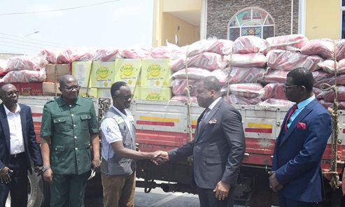 Rev. Dr Stephen Wengam (right) handing over the items to  Ernest N. Asigri, Executive Director of AG CARE-GHANA, for distribution to the flood victims in North Tongu in the Volta Region