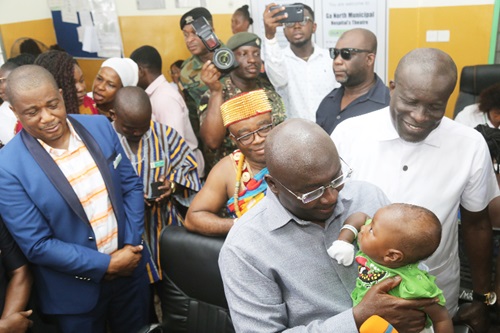 Vice-president Dr Mahamudu Bawumia (with a baby) after the launch of the Ghana Card at Birth at the Ga North Municipal Hospital in Accra. With him is Dr Victor Caesar (left), Medical Superintendent, Ga North Municipal Hospital. Picture: SAMUEL TEI ADANO