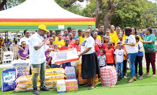 Gilbert Abeiku Aggrey Santana (left), Executive Secretary of Boameman Ghana Foundation, presenting the items to a representative of Assurance of Hope for the Needy