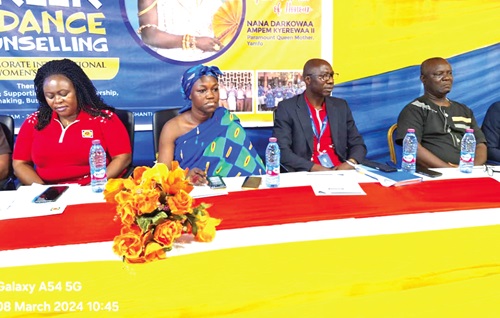Vivian Carrey, General Manager, Employment Relations of ECG, and Nana Darkowaa Ampem Kyerewaa II, Queenmother of Yamfo Traditional Council, with some management members of ECG at the programme