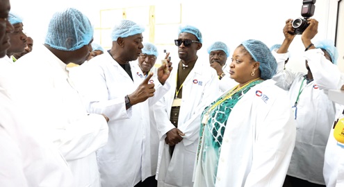 Moses Baiden (2nd from left), the CEO of Margins ID Group, explaining the operations of the company to the MPs during the visit