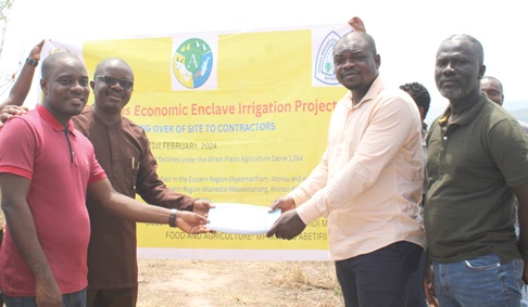 Isaac Agyapong (left), the District Chief Executive of Kwahu East, and Engineer Oppong Boateng (2nd from left), the Chief Executive of GIDA, handing over the terms of reference and site documents to Dr Simon Ofori, the Director of Camelitos Company Limited