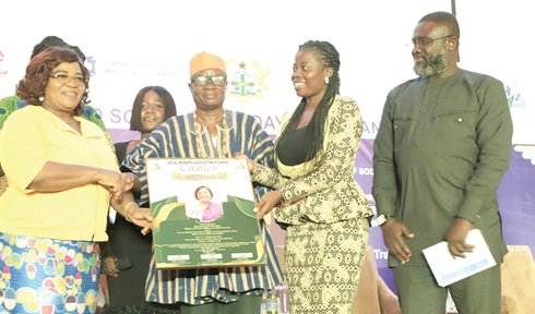Divine Exorgbe (3rd from right), President of GASOW, presenting a citation to Rev. Dr Comfort Asare (left), Director, Social Welfare Department, Ministry of Gender, Children and Social Protection. With them are some officials of the GASOW. Picture: EDNA SALVO-KOTEY