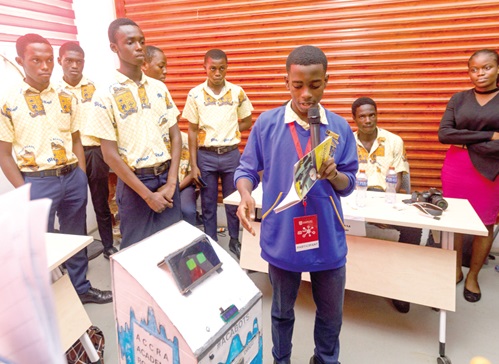  A member of the Accra Academy Robotic Club explaining the invention project at the Tech Expo at the Academic City University College in Accra