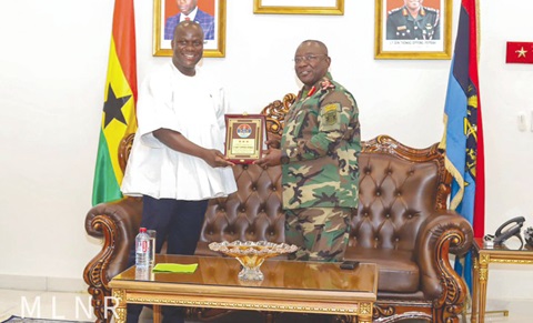 Lt Gen. Thomas Oppong-Peprah (right), Chief of Defence Staff, presenting a plaque to Samuel Jinapor, Minister of Lands and Natural Resources, when the latter  paid a courtesy call on him in Accra