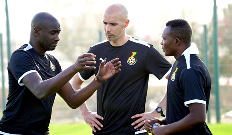 Coach Otto Addo (left) in a discussion with Joseph Laumann and John Paintsil, two of his assistants, at the team's Marrakech training base