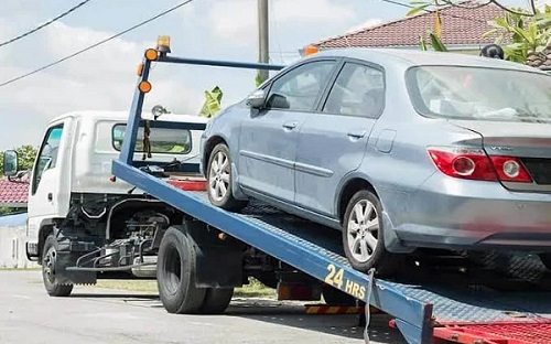 FILE PHOTO: A car on towing vehicle 