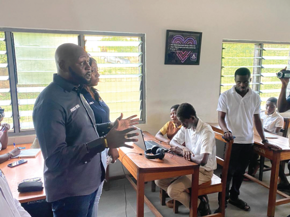 Prince Ofosu Sefah (left), Chief Executive Officer of GIFEC, interacting with some of the beneficiaries