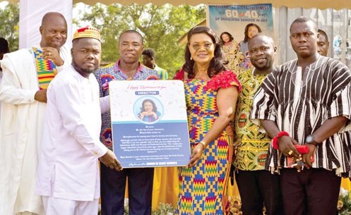 Dorcas Brenda Asare (3rd from right), former Director of Education, receiving a citation from Daniel K. Essel, CEO of Crown of Glory Schools. With them are Apostle Benjamin Darko, Isaac Oscar Odoom (3rd from left), Chairman, Central Conference of Directors of Education; Richardson Kakra (2nd from right), PM for Ekumfi, and ⁠Nana Baffoe Aikins (right), PRO, Ekumfi District Directorate of Education